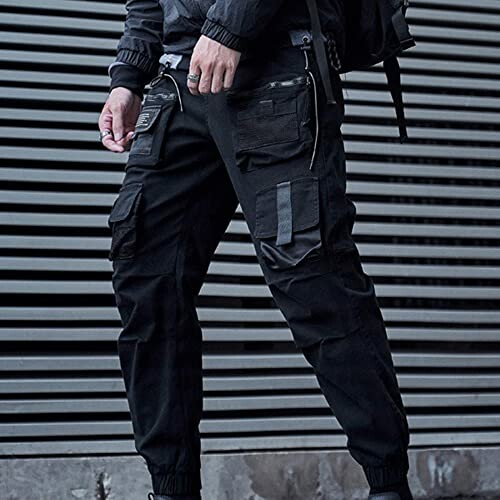 Person wearing black cargo pants with multiple pockets