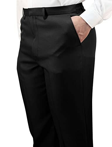 Close-up of person wearing black dress pants with hand in pocket