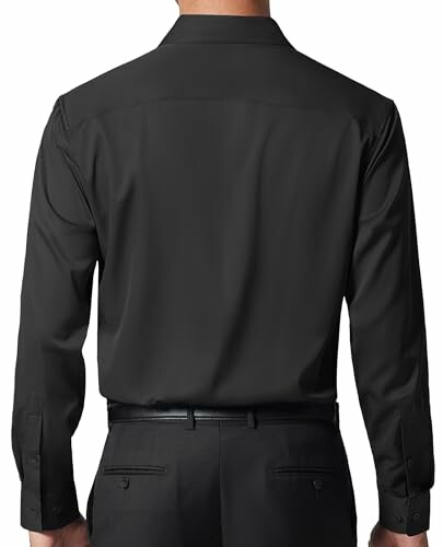 Back view of person wearing black dress shirt and pants.