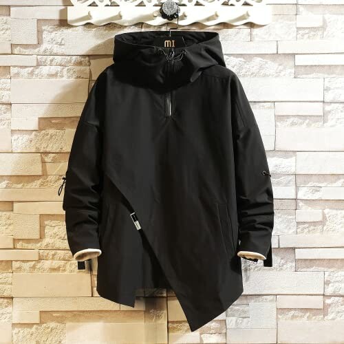 Black hooded jacket on a hanger against a brick wall