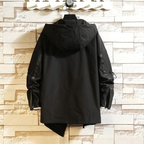 Black hooded jacket hanging on a wall