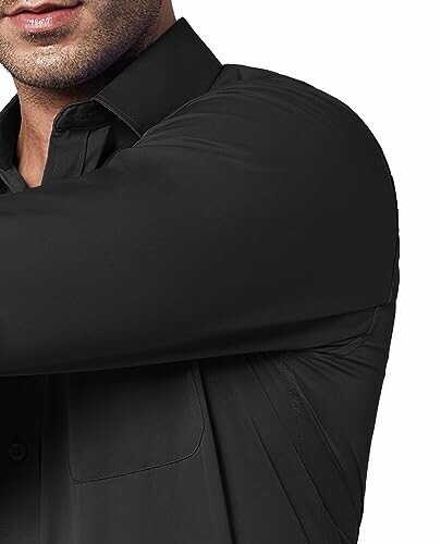 Close-up of a person wearing a black shirt.