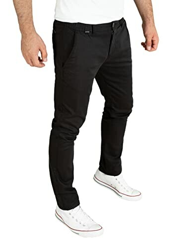 Person wearing black slim-fit chinos and white sneakers