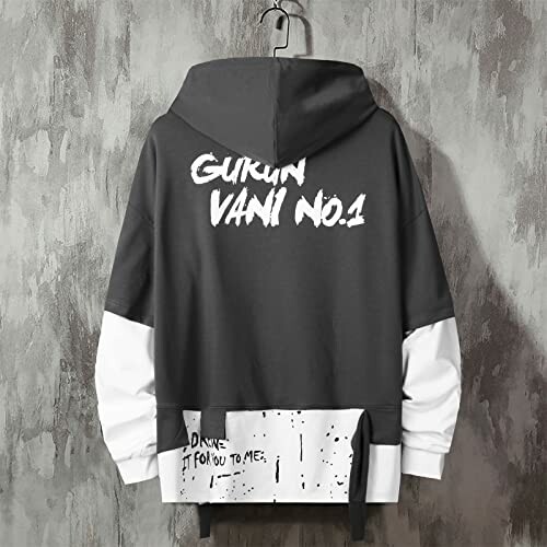 Black and white hoodie with graphic text on a hanger.