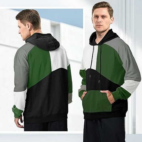 Man wearing a color-block hoodie in green, black, and white.