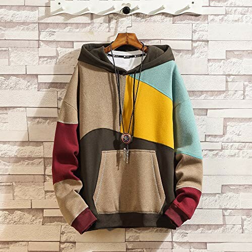 Color-block hoodie with geometric design hung on wall