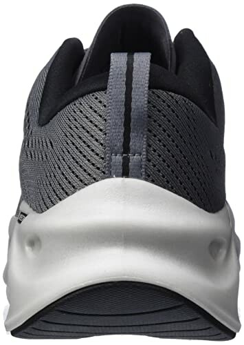 Back view of a gray and black sneaker with a white sole