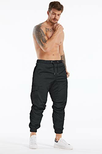 Shirtless man wearing black joggers and white sneakers