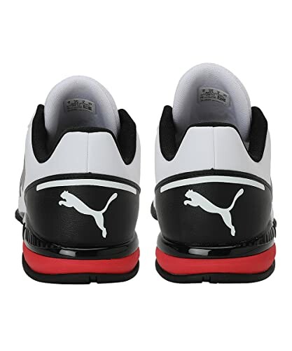 Back view of black and white Puma sneakers with red accents.