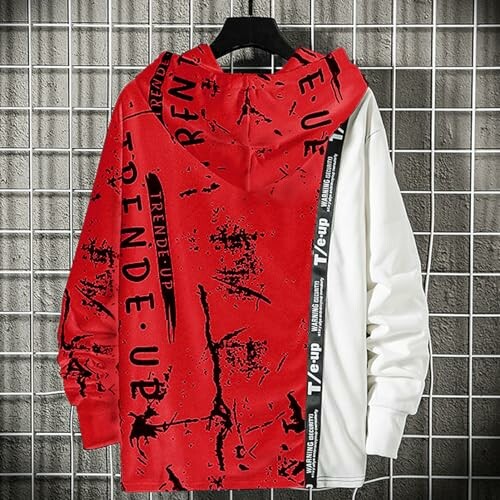 Red and white graphic hoodie hanging on a hanger