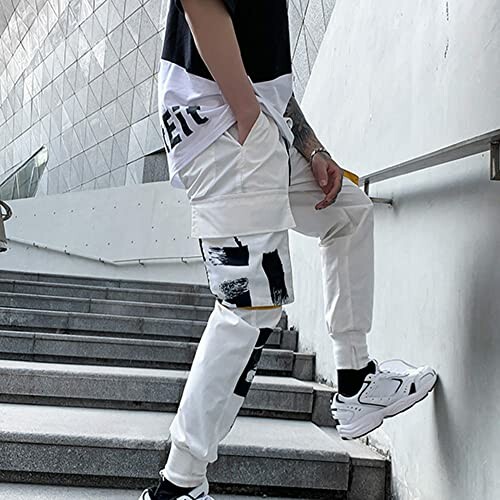 Person wearing stylish white cargo pants on stairs.