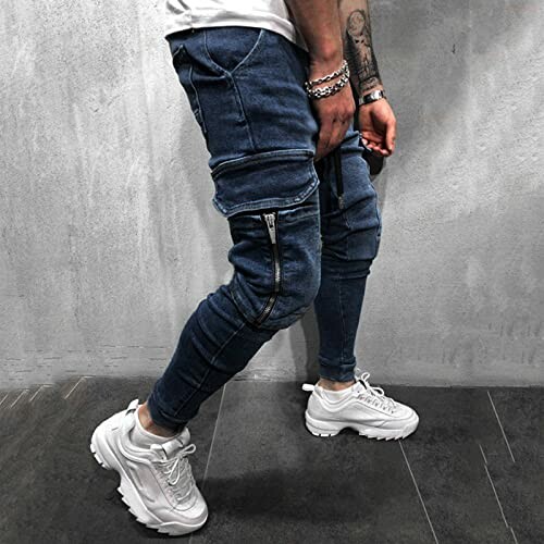 Person wearing blue denim joggers and white sneakers.