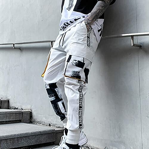 Person wearing white and black urban streetwear pants.