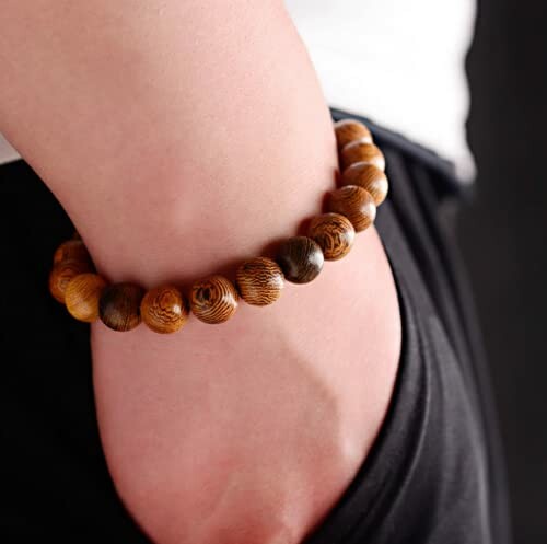 Wooden bead bracelet on a person's wrist.